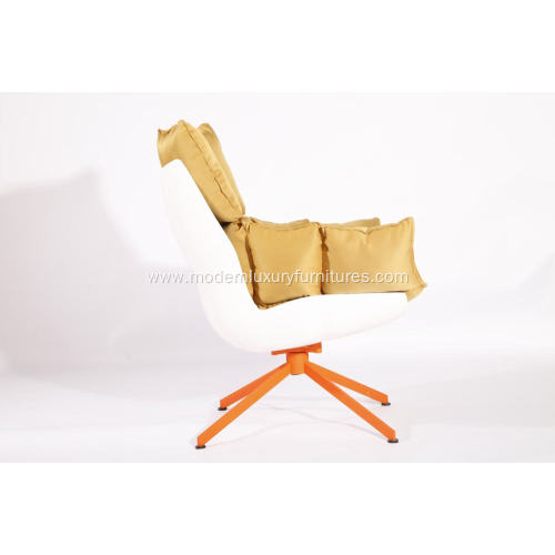 white husk chair with orange seat cushion
